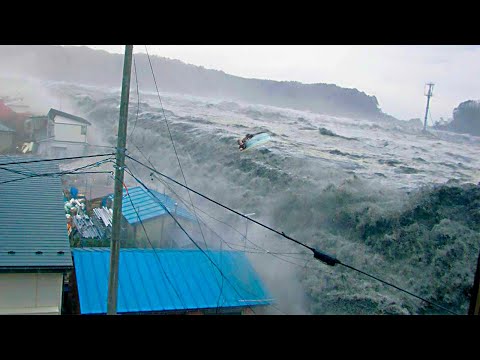A tsunami wave sweeps houses away after a volcanic eruption in Tongatapu, Tonga