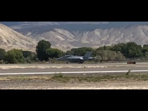 F-18 taking off with a exotic car escort.