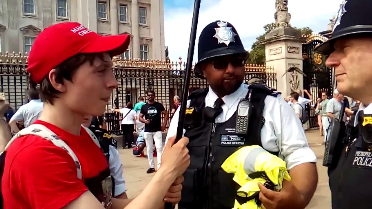 RED CAP BOY TOLD TO LEAVE  THE AREA OUT SIDE BUCKINGHAM PALACE FOR FLYING TRUMP FLAG
