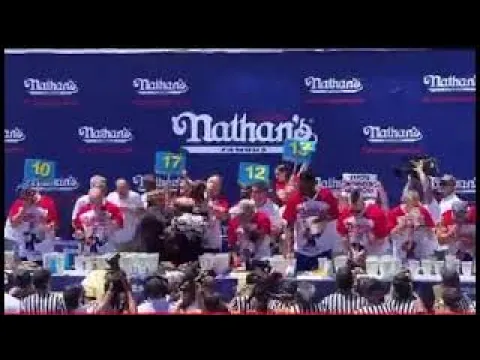Hot Dog Eating Champ Joey Chestnut Chokes Out Animal Rights Protester,with mouthful of dogs