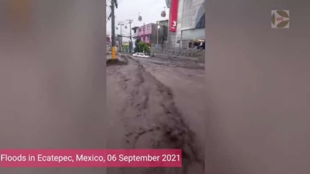MEXICO -mud and flood water flowing through streets, dragging along vehicles and.mp4