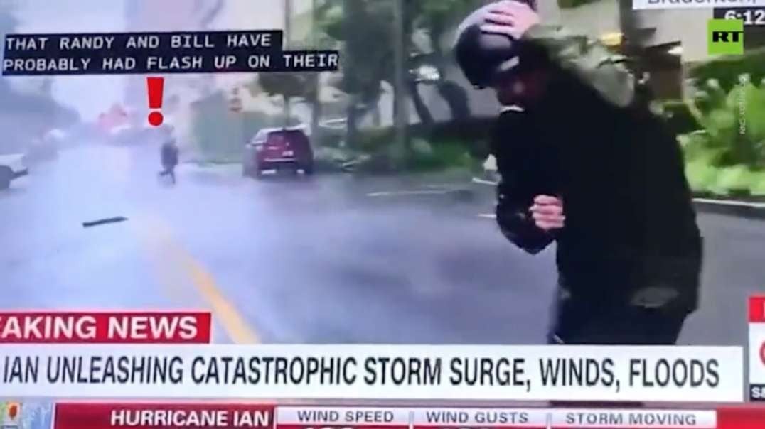 Man calmly walks and gets in car during exaggerated CNN hurricane report