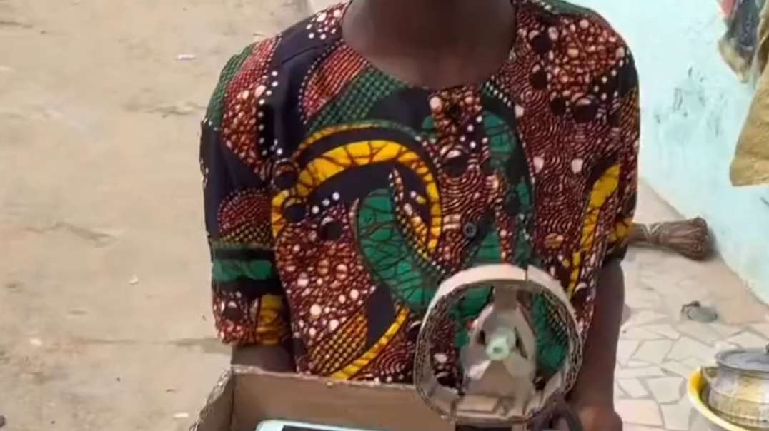 An 11-year-old Ivorian creates a fan/phone charging station from recycled products