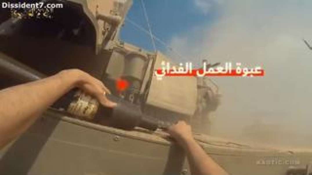 Israeli controlled Hamas placing a charger on the tank or is it a smoke bomb like the Boston bombing