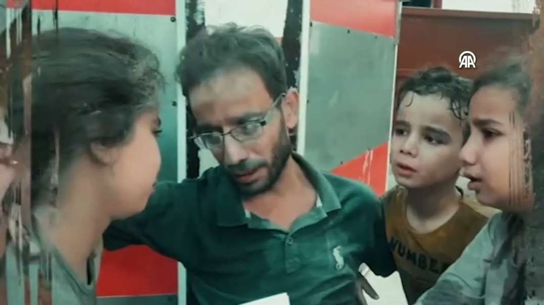 GAZA - Palestinian Father Comforts His Children Crying for Fear of Bombardment